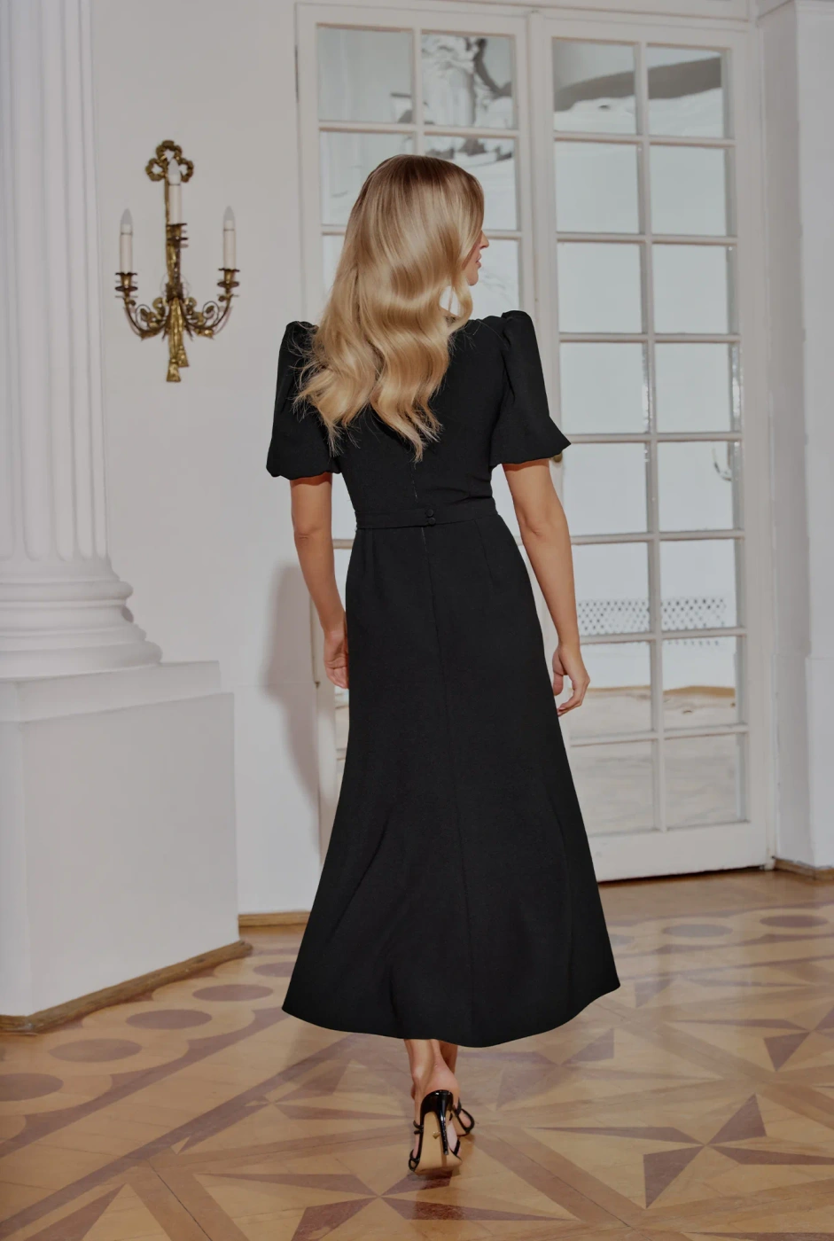 Hover - Black maxi dress with bouffant sleeves, straight top, flared bottom, buckled belt with detachable applique and pointed neckline