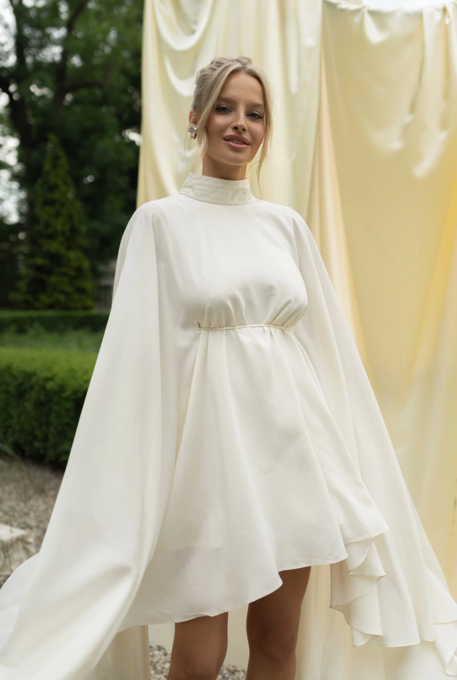 Larumi – ecru maternity dress with a cape silhouette