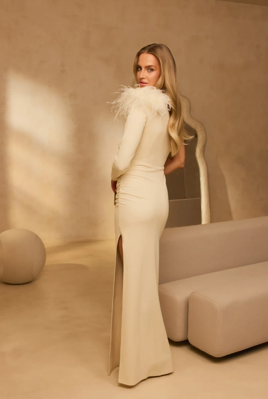 Elegante – asymmetrical maxi dress in ecru with a feather brooch