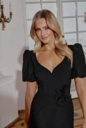 Hover - Black maxi dress with bouffant sleeves, straight top, flared bottom, buckled belt with detachable applique and pointed neckline